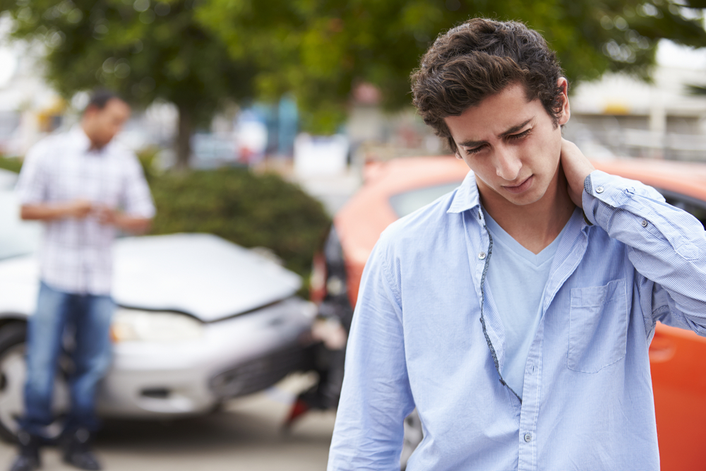 Common Myths About Car Accident Claims - Teenage Driver Suffering Whiplash Injury Traffic Accident