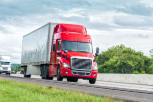 Truck Accident Lawyer Columbus, OH - Red Eighteen Wheeler Travels Interstate Highway